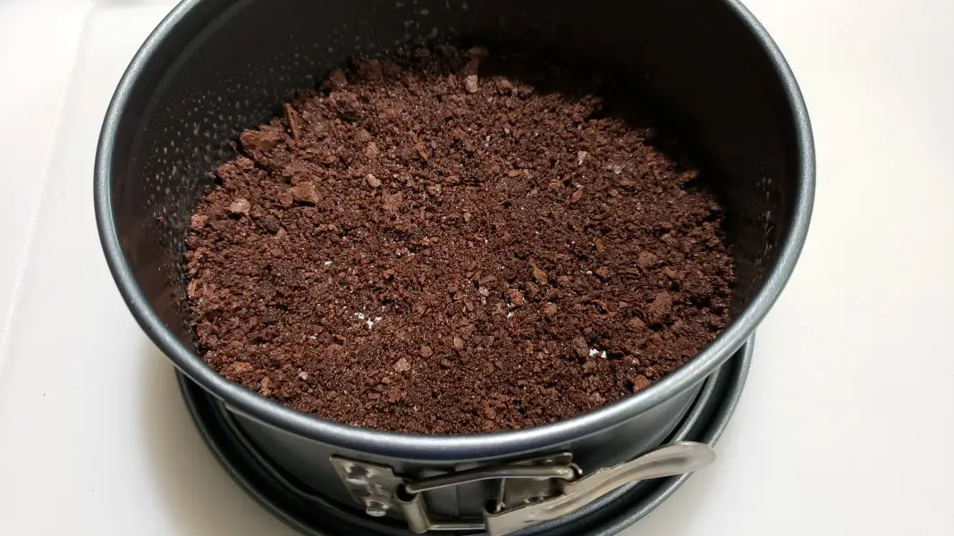 chocolate graham crumb mixture pressed into a springform pan.