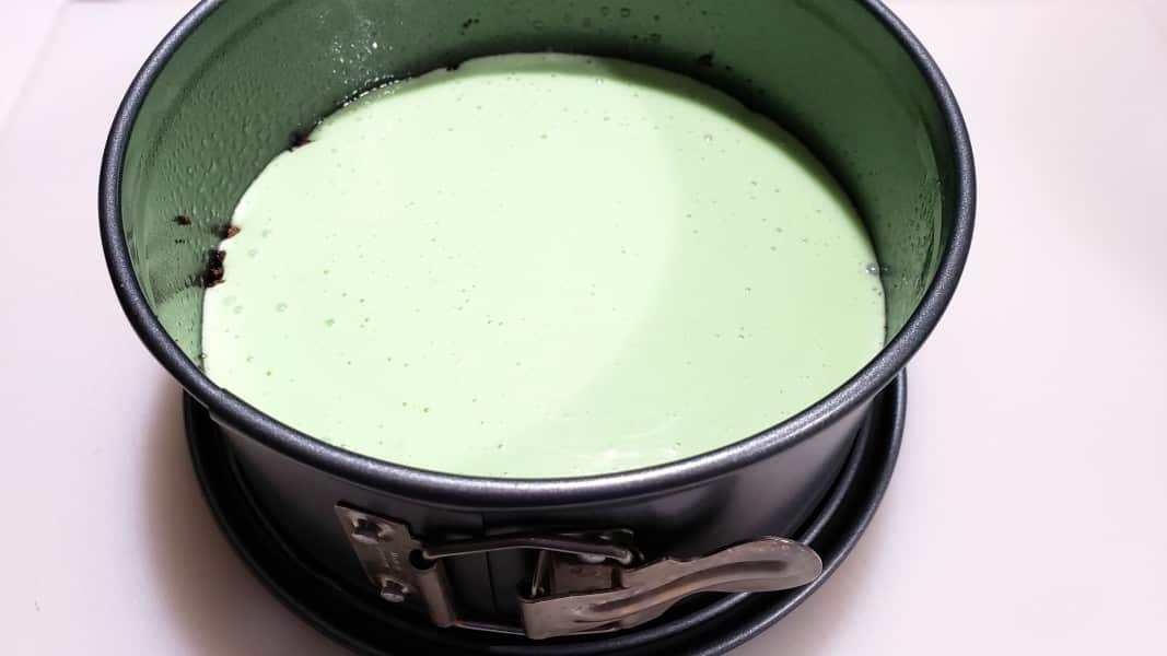 mint cheesecake filling poured into a springform pan
