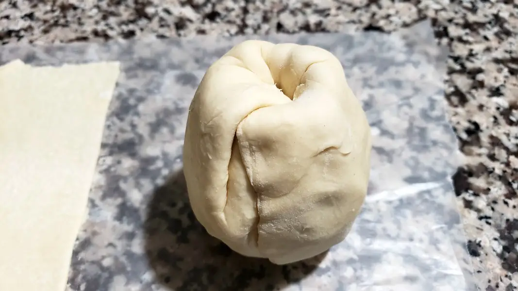a pear tightly wrapped with puff pastry.