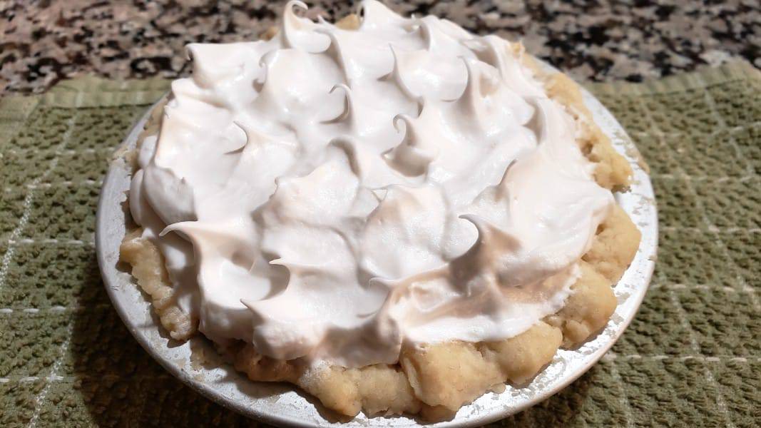 unbaked lemon meringue pie with meringue peaks.