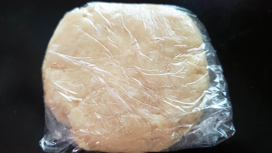 pie crust dough wrapped in plastic wrap.