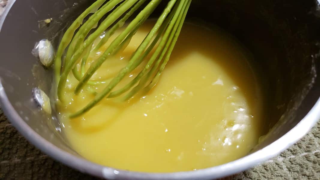 lemon pie filling from scratch cooking in a pan