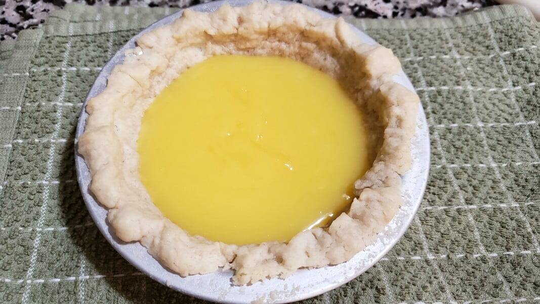 homemade lemon pie filling in baked pie crust.