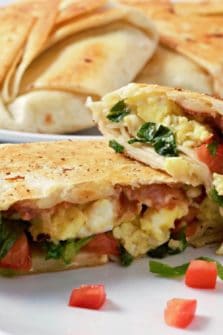 Breakfast Crunchwraps cut open on a plate.