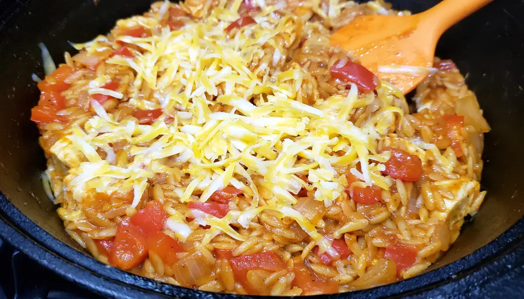 chicken taco orzo cooking in a skillet