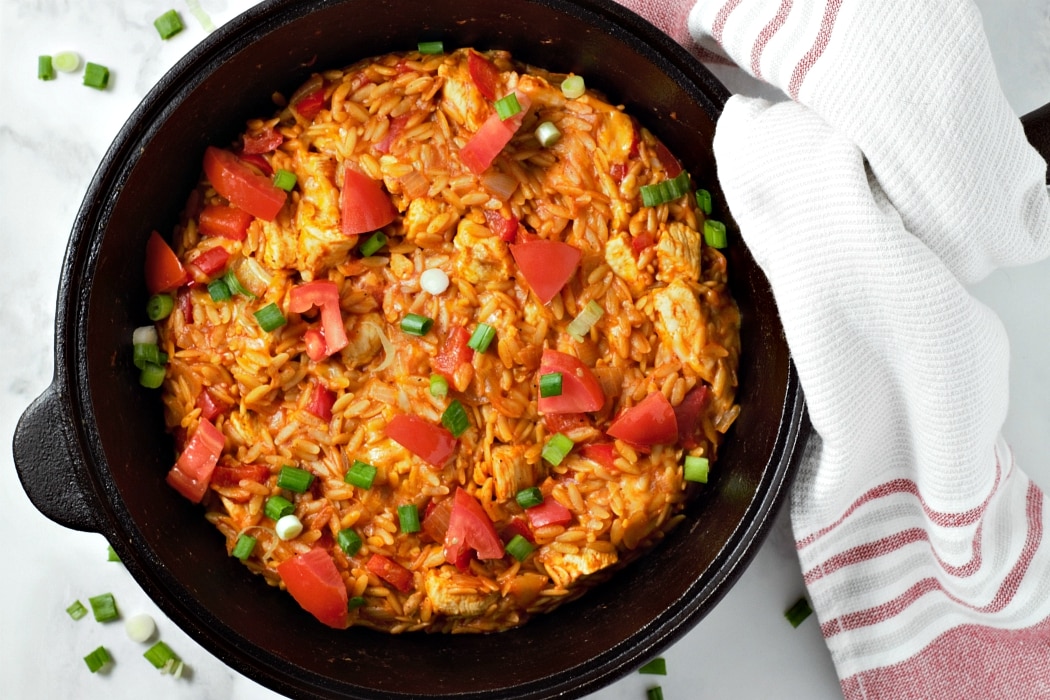 Chicken Taco Orzo in a skillet with Mexican seasonings, cheese, and tomatoes