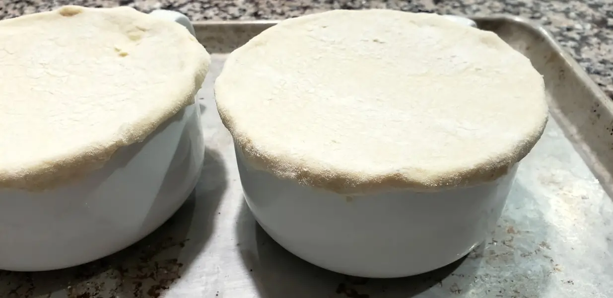 puff pastry circles added to tops of beef pot pie bowls