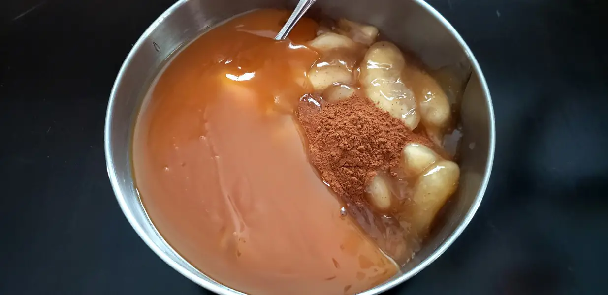 apple pie filling, cinnamon, and caramel in a bowl