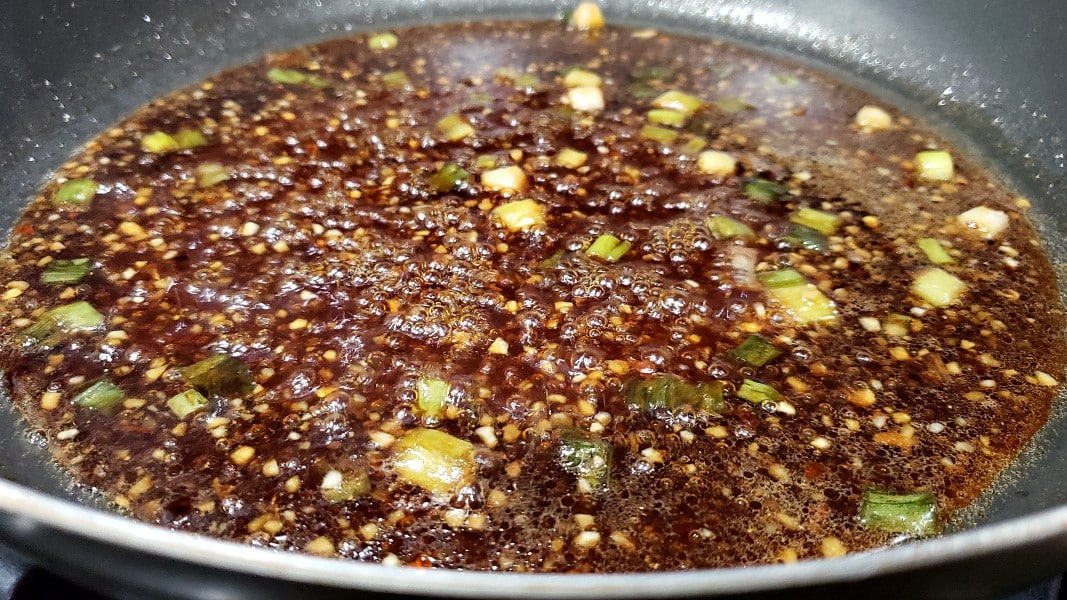 General Tso's sauce cooking in a frying pan.