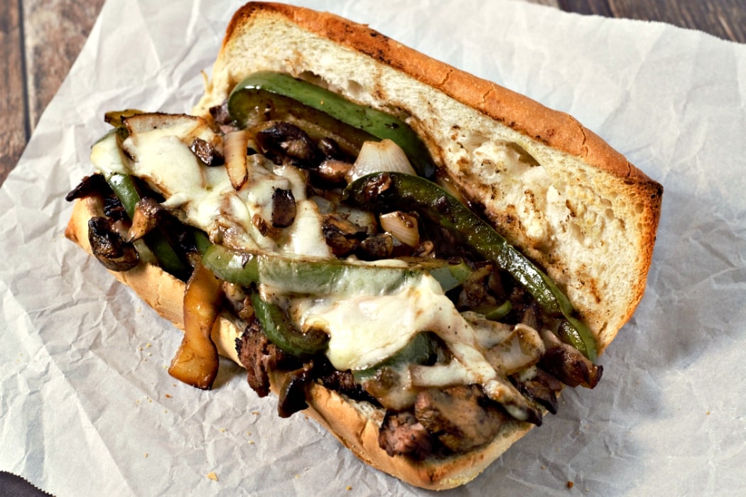 a Ribeye Philly Cheesesteak Sandwich on parchment paper