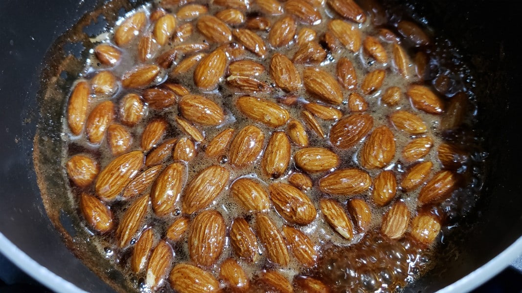 cinnamon almonds cooking in a pan.