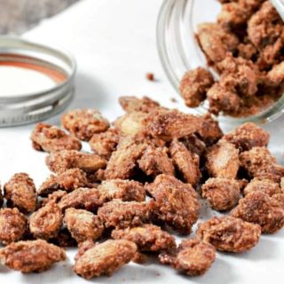 Candied Cinnamon Almonds pouring out of a jar.