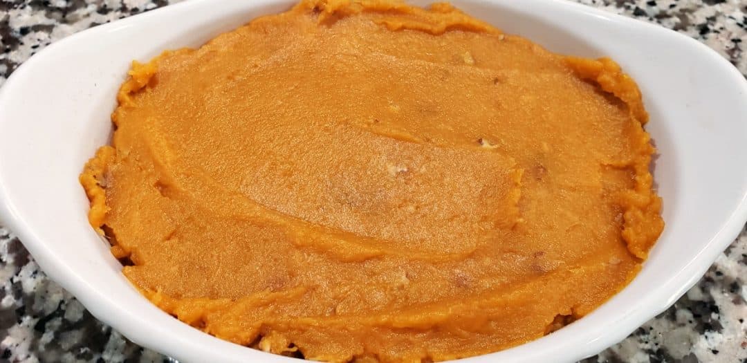 mashed sweet potato mixture pressed into a baking dish