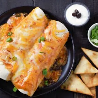 Chicken and Black Bean Enchiladas with sour cream and green onion