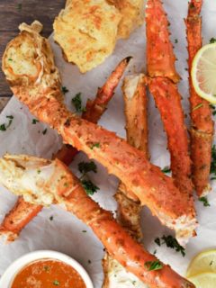 Baked Crab Legs on parchment paper.