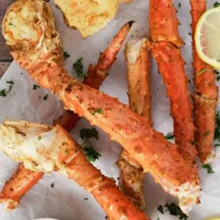 Baked Crab Legs on parchment paper.