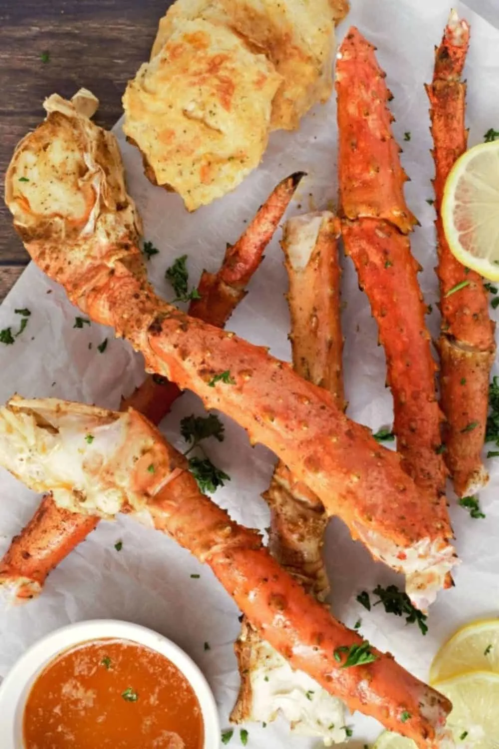 Baked Crab Legs on parchment paper.