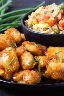 Baked Sweet and Sour Chicken with Homemade Fried Rice on a plate.