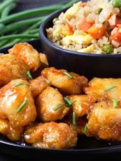 Baked Sweet and Sour Chicken with Homemade Fried Rice on a plate.