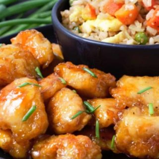 Baked Sweet and Sour Chicken with Homemade Fried Rice on a plate.