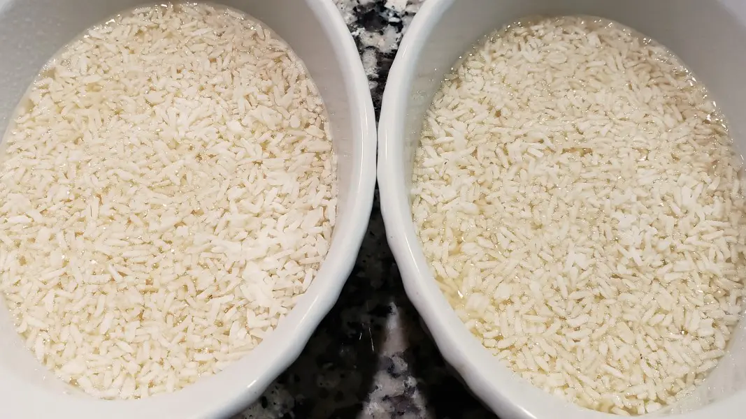 uncooked rice and chicken broth in two baking dishes