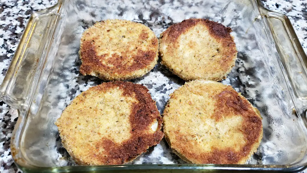 4 fried eggplant slices in a baking dish