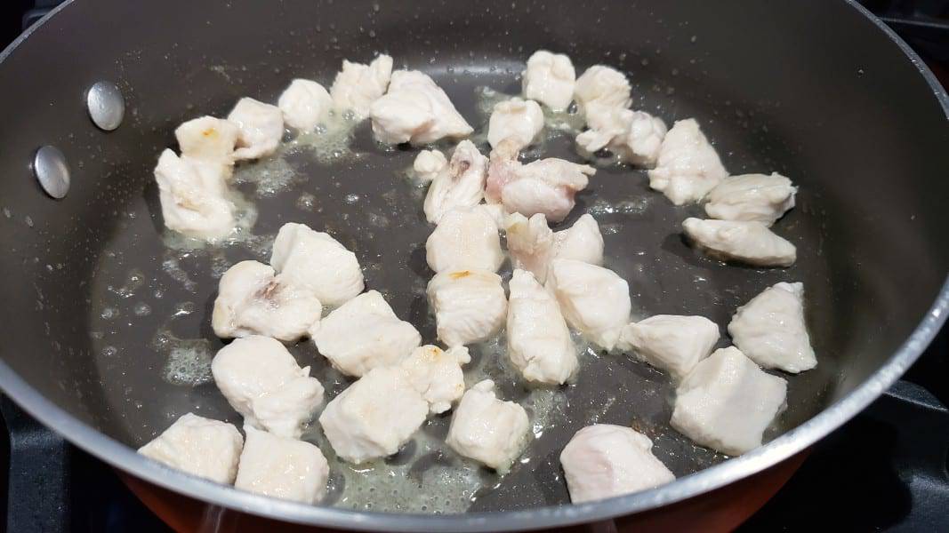 diced chicken cooking in a skillet