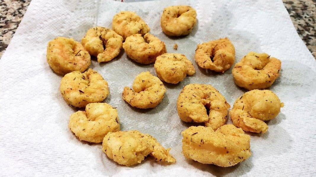 fried shrimp draining on paper towel