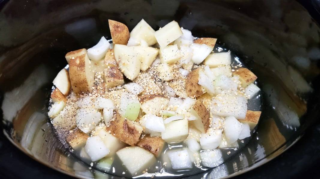 potatoes, onion, chicken broth, garlic, salt and pepper in slow cooker
