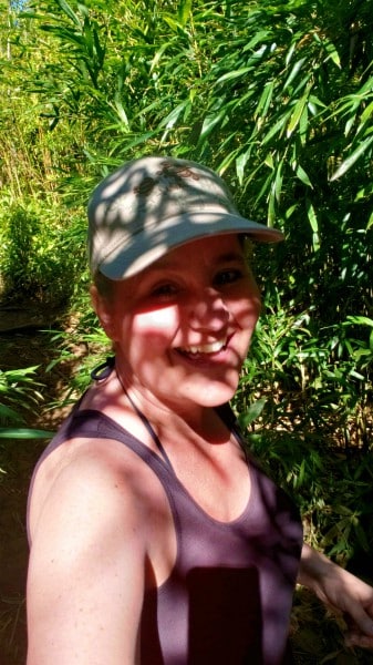 a woman taking a selfie in the bamboo forest