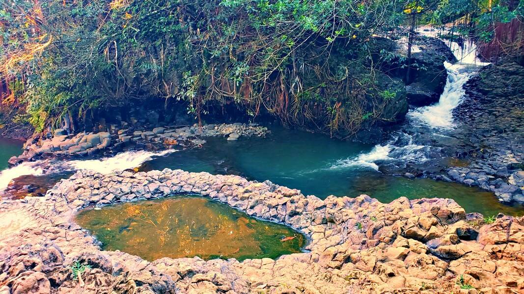 a waterfall flowing into a stream