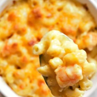 Baked Shrimp Macaroni and Cheese in a bowl with a spoon lifting some out.