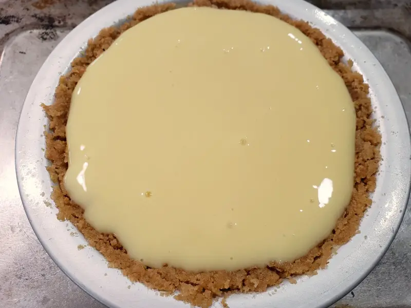 lime pie filling poured into graham crust