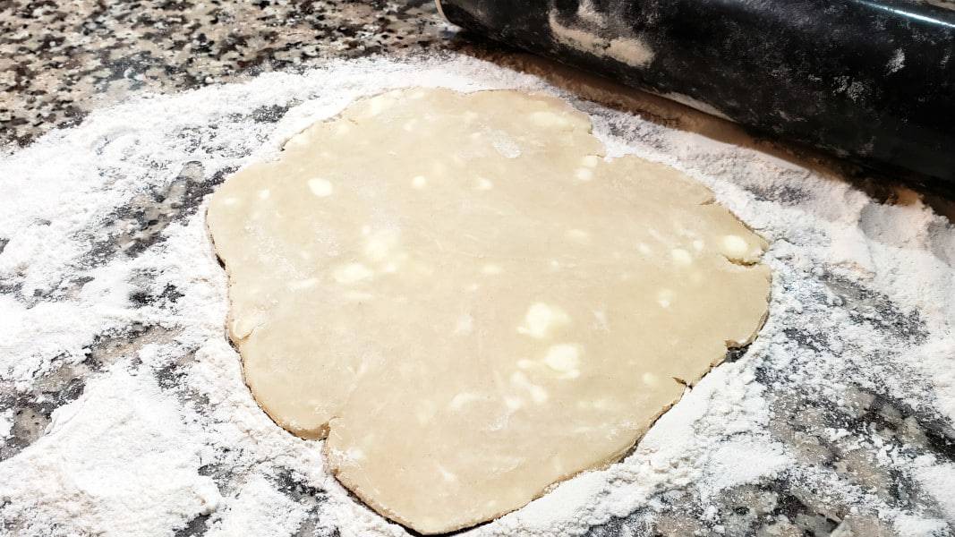 small pie dough rolled out into a rough circle