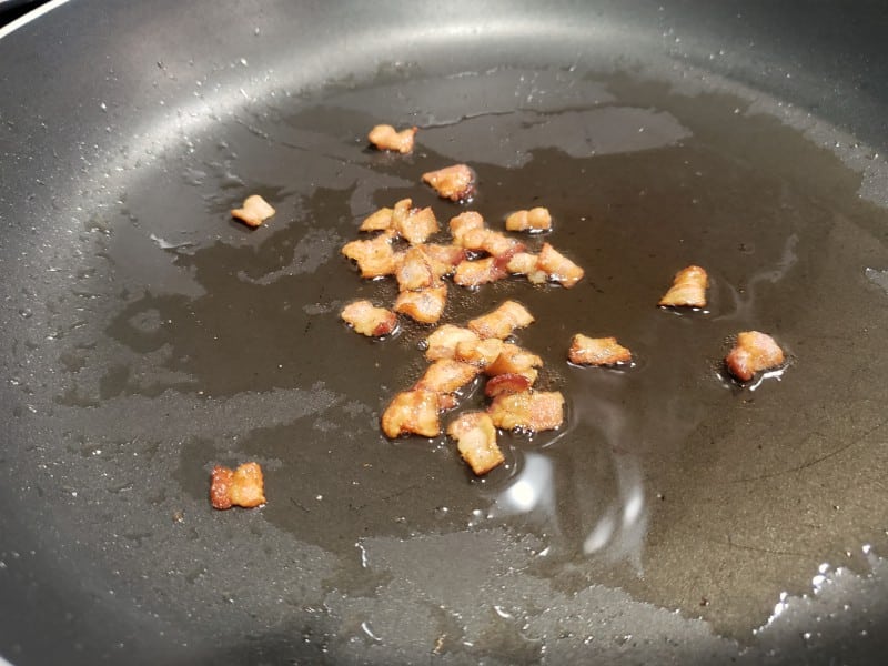 bacon crumbles cooking in a skillet