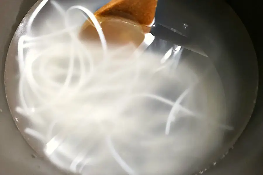 thai rice noodles soaking in boiling water