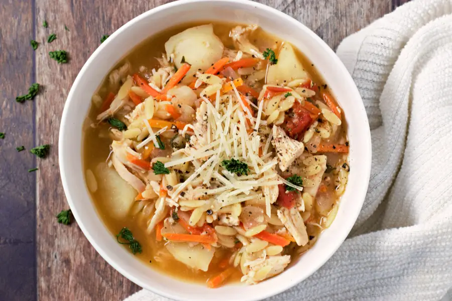 Tuscan Chicken Orzo Soup in a white bowl