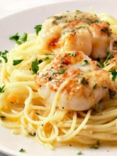 Baked Buttery Sea Scallops with Pasta on a plate.