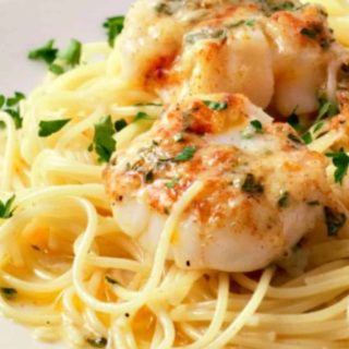 Baked Buttery Sea Scallops with Pasta on a plate.