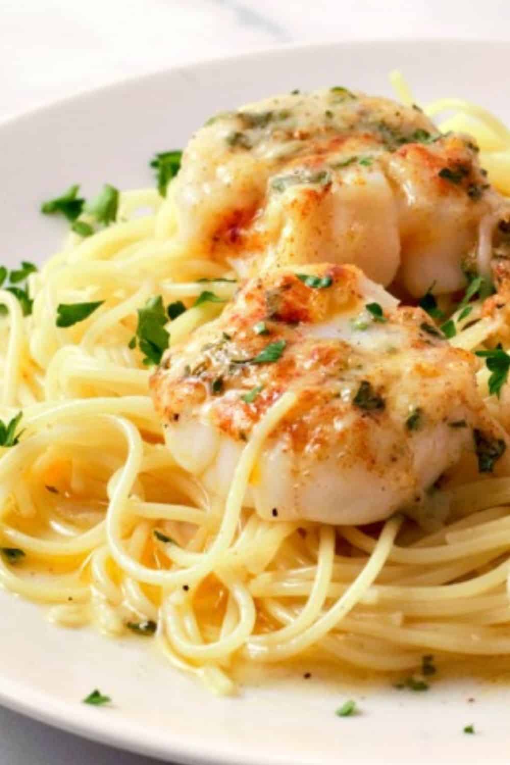 Baked Buttery Sea Scallops with Pasta on a plate.