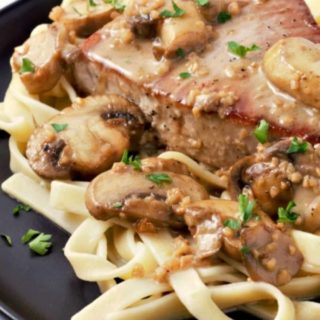 Creamy Mushroom Tuna Steak over noodles on a plate.