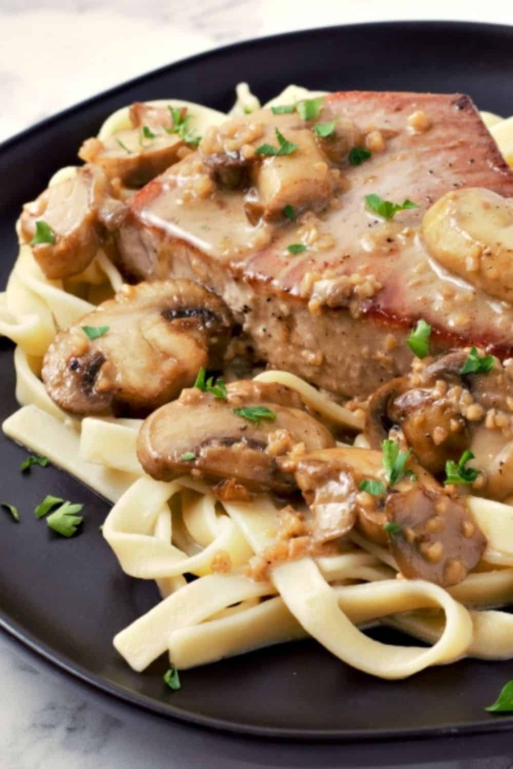 Creamy Mushroom Tuna Steak over noodles on a plate.