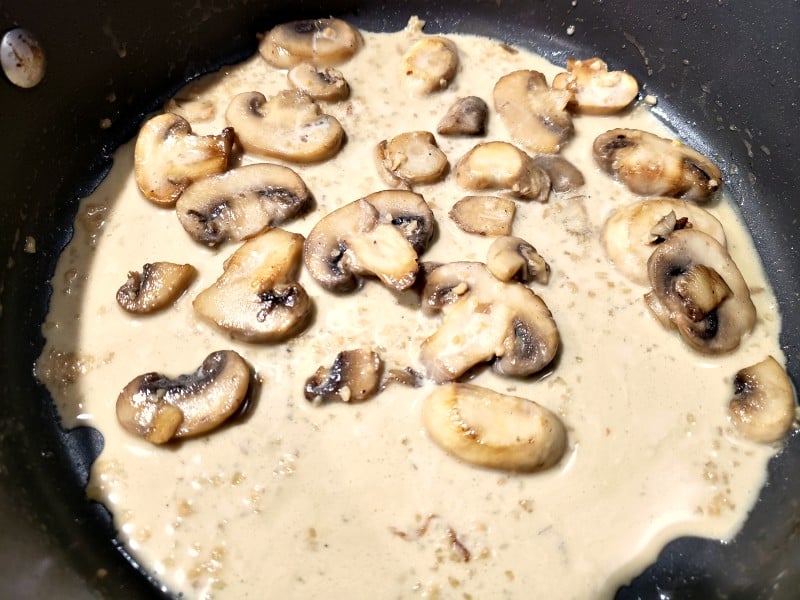 creamy mushroom sauce cooking in a pan