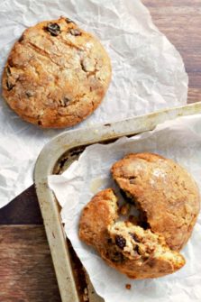 Glazed Cinnamon Raisin Biscuits on parchment paper.