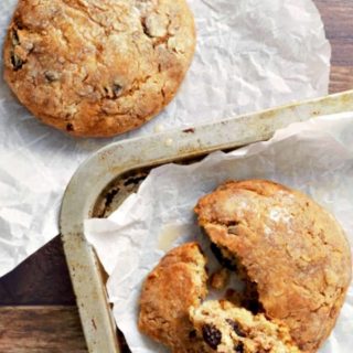 Glazed Cinnamon Raisin Biscuits on parchment paper.