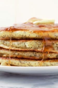 Lemon Poppy Seed Pancakes in a stack on a plate.