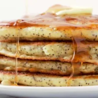 Lemon Poppy Seed Pancakes in a stack on a plate.