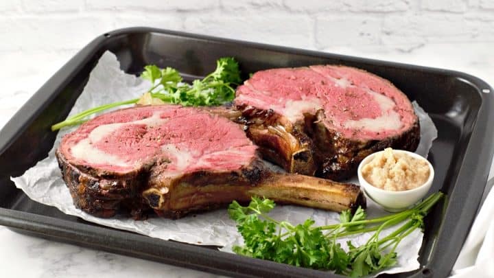 Two Prime Rib Roast steaks with a side of horseradish