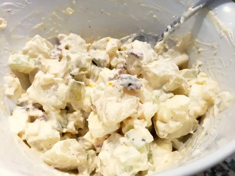 creamy potato salad mixed in a bowl