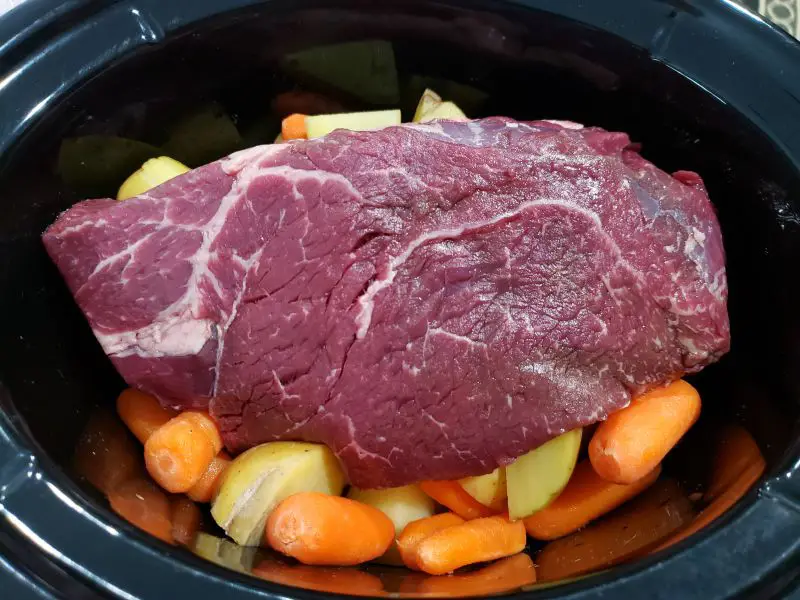 potatoes, carrots, and beef roast in a crockpot